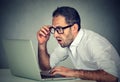 Young shocked man using laptop computer sitting at table Royalty Free Stock Photo