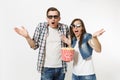 Young shocked scared couple, woman and man in 3d glasses watching movie film on date, holding bucket of popcorn Royalty Free Stock Photo