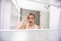 Young shocked woman looking in empty fridge at home Royalty Free Stock Photo