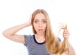 Young shocked woman showing her damaged split ends of hair Royalty Free Stock Photo