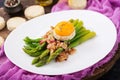 Young shoots of asparagus with ham and chicken egg yolk Royalty Free Stock Photo