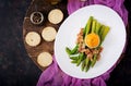 Young shoots of asparagus with ham and chicken egg yolk on toast Royalty Free Stock Photo