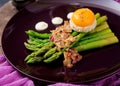 Young shoots of asparagus with ham and chicken egg yolk Royalty Free Stock Photo