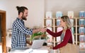 Young shop assistant and an attractive woman in a zero waste shop, shaking hands. Royalty Free Stock Photo