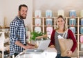 Young shop assistant serving an attractive woman in a zero waste shop. Royalty Free Stock Photo