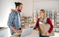 Young shop assistant serving an attractive woman in a zero waste shop. Royalty Free Stock Photo