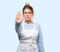 Young shop owner woman wearing apron