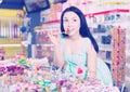 Young shopgirl with lollipop at gifts shop