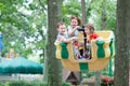 Young siblings, 1 boy and 2 girls, having fun on boardwalk amusement ride Royalty Free Stock Photo