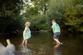 Young siblings playing in river Royalty Free Stock Photo