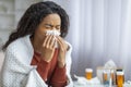 Young Sick Black Woman Blowing Nose In Paper Tissue At Home Royalty Free Stock Photo