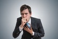 Young sick businessman is coughing