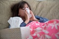 Young sick girl blowing her nose with tissue paper Royalty Free Stock Photo