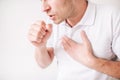 Young sick man isolated over white background. Cut view and close up of guy holding fist close to mouth and cough. Pain Royalty Free Stock Photo