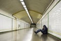 Young sick man lost suffering depression sitting on ground street subway tunnel Royalty Free Stock Photo