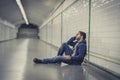 Young sick man lost suffering depression sitting on ground street subway tunnel Royalty Free Stock Photo