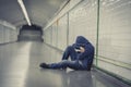 Young sick man lost suffering depression sitting on ground street subway tunnel Royalty Free Stock Photo