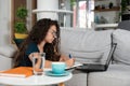 Young sick schoolgirl or student girl doing online homework or educational exam for college, using laptop computer. Ill teenager Royalty Free Stock Photo