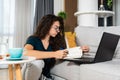 Young sick schoolgirl or student girl doing online homework or educational exam for college, using laptop computer. Ill teenager Royalty Free Stock Photo