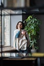 Young sick unhealthy female employee with seasonal flu influenza symptoms drinking hot tea in office Royalty Free Stock Photo