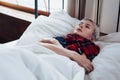 A young sick woman in bed with chills Royalty Free Stock Photo