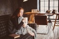 Young sick woman healing with hot drink at home on cozy couch Royalty Free Stock Photo