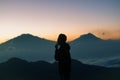 A young silhouette mountain climber at sunrise
