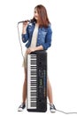 Young singer with microphone and synthesizer. Royalty Free Stock Photo