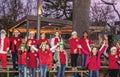 Young singers from local school in Christmas costumes sing at Gathering Place public park in Oklahoma