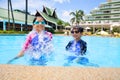 Young sister and her brother in swimming pool
