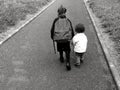 Young sister walks with her older sister to school