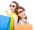 Young sisters holding shopping bags and Back to back