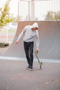 Young skate boy doing trick in skating park outdoors. Sport concept. Royalty Free Stock Photo