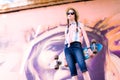 Young skateboard girl holding her longboard outdoors Royalty Free Stock Photo