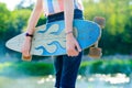 Young skateboard girl holding her longboard outdoors on sunset Royalty Free Stock Photo