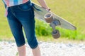 Young skateboard girl holding her longboard outdoors on sunset Royalty Free Stock Photo