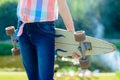 Young skateboard girl holding her longboard outdoors on sunset Royalty Free Stock Photo