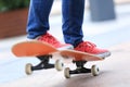 Young skateboarder legs riding on skateboard