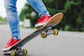 Young skateboarder legs riding on skateboard on city Royalty Free Stock Photo