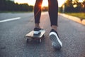 Young skateboarder legs riding on skateboard