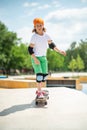 Young skateboarder practicing his skateboarding skills on the sports ground Royalty Free Stock Photo