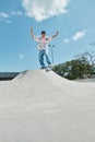 A young skater boy joyfully rides Royalty Free Stock Photo