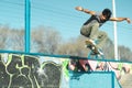Young skater boy jumping high above the concrete of skate park Royalty Free Stock Photo