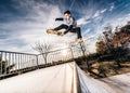 Young skater making a jump on Skatepark during sunset Royalty Free Stock Photo