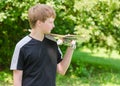 Young skater with skateboard on shoulder