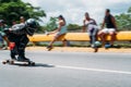 Barcelona, Spain - 20 july 2018: fearless young man doing downhill speed skating in open street with black mask