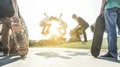 Young skaters jumping with skateboard in city suburb park - Sporty guys performing tricks and skills at sunset - Extreme sport Royalty Free Stock Photo