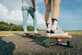 Young skaters riding a skateboard on the road on a sunny day