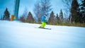 Young skier going quickly down the slope Royalty Free Stock Photo