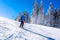 Young skier in motion with a beautiful winter landscape in the background